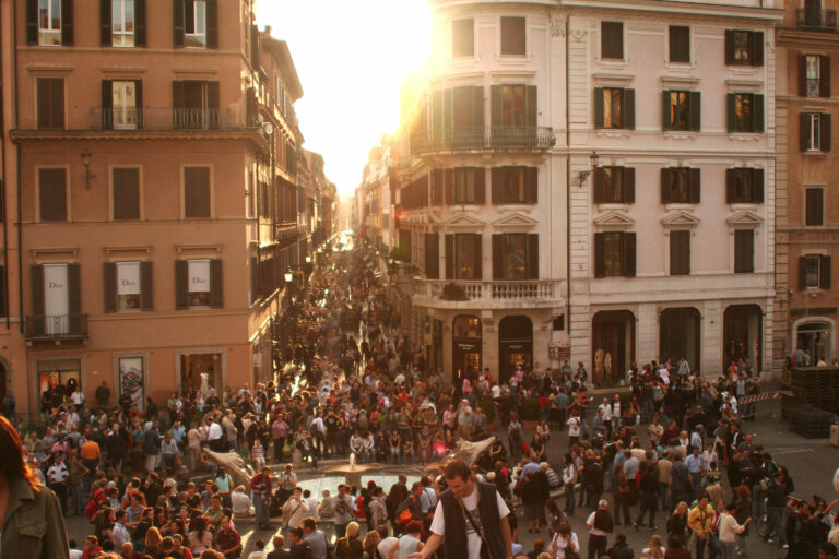 People gathering in streets during sunset
